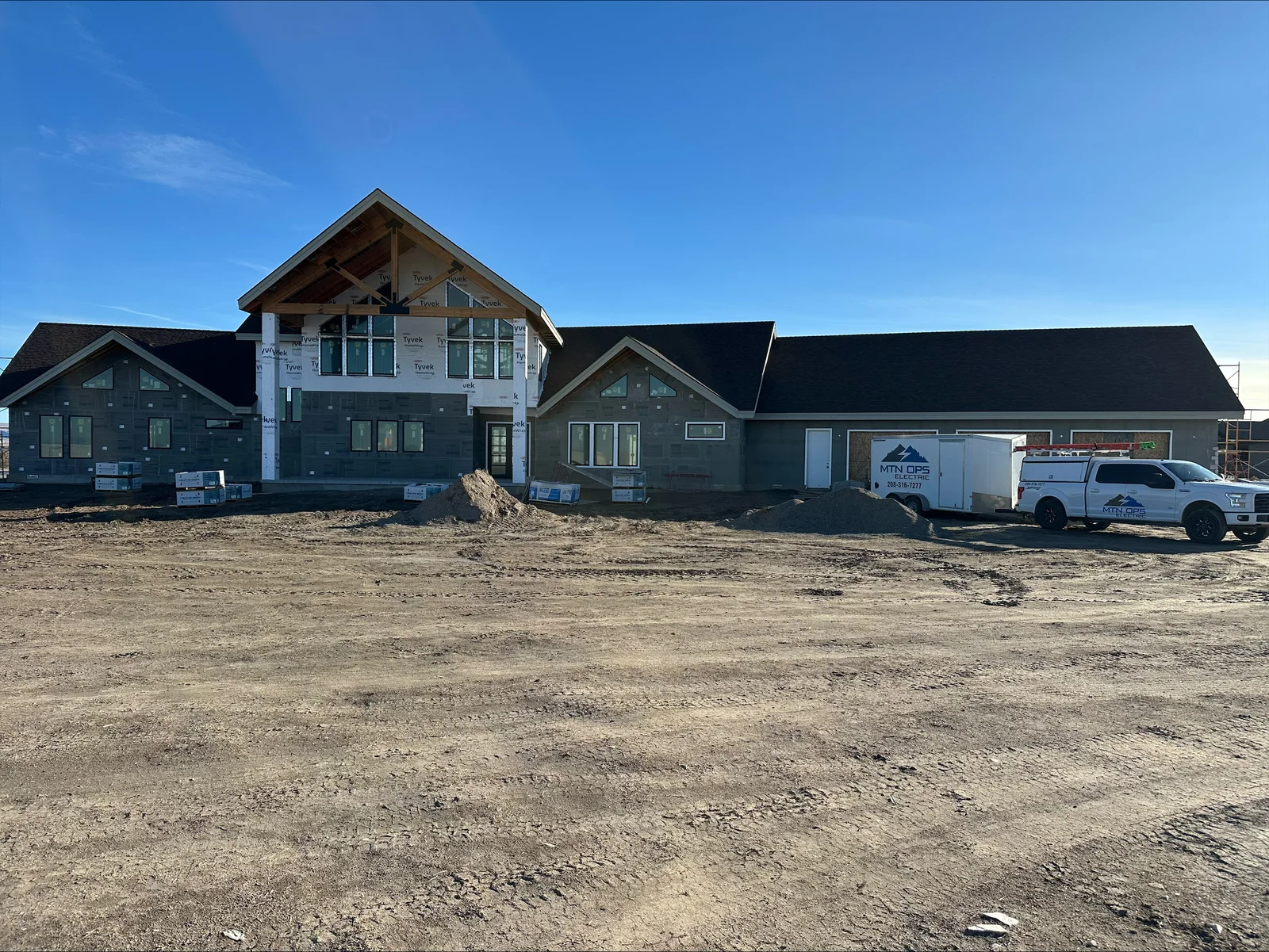 New home construction with electrical rough-in wiring visible in gable sections and framed walls
