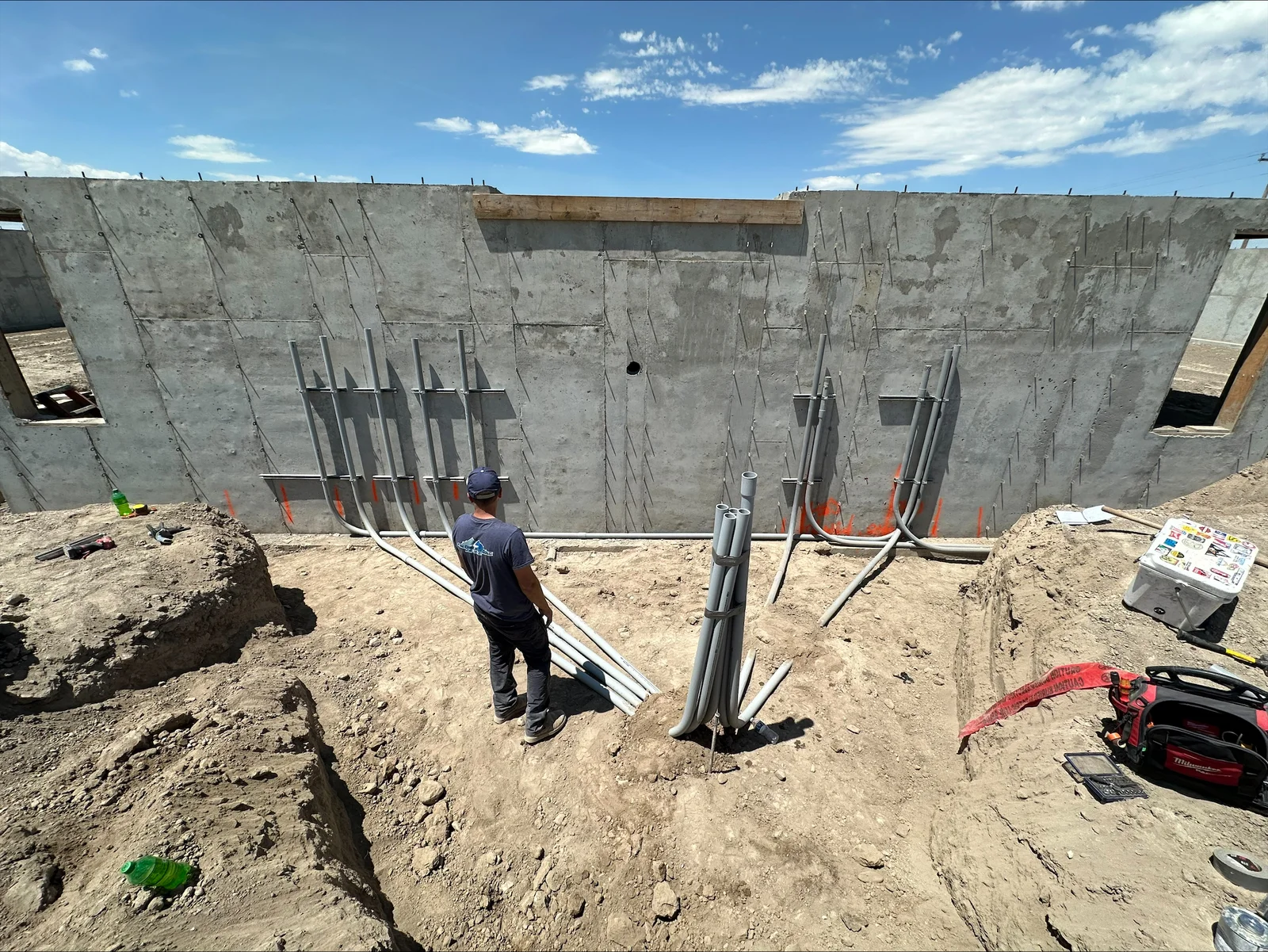 Electrical conduit and junction boxes installed in concrete foundation walls during construction phase
